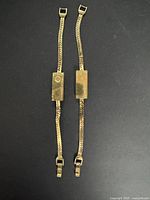 Two matching gold-tone bar bracelets