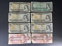 Eight Bank of Canada notes laid out showing obverse designs