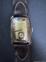 Front view of Bulova rectangular wristwatch showing dial, hands, strap