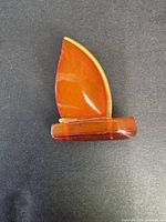 Front view of amber sailboat brooch