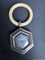 Full view of rattle showing Bakelite ring and silver hexagonal head