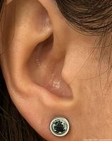 Earring worn on ear showing size and setting