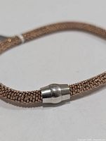 Close-up of magnetic clasp and mesh texture