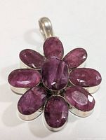 Front view of silver pendant showing ruby arrangement