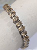 Full view of silver bracelet with oval citrine stones