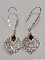 Front view of both earrings showing filigree design and red agate stones