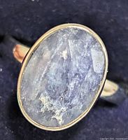 Front view of ring showing oval sapphire cabochon and bezel setting