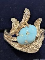 close-up of silver ring featuring oval turquoise stone