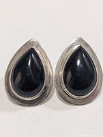 Front view of teardrop sterling earrings with black onyx stones