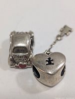 Car and heart silver beads side by side