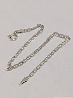 Full view of silver chain bracelet laid out flat