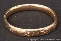 Top view of entire bracelet showing floral engraving