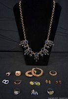 Overview of all jewellery items on display bust and cloth