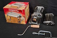 Full set showing pasta maker, cutter, crank, clamp and box