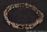Full view of silver bracelet with multicolour stones