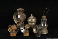 Group shot of all eight antique lamps and parts