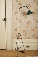 Full view of tripod rocket floor lamp against wall