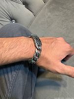 Bracelet worn on wrist showing chain links