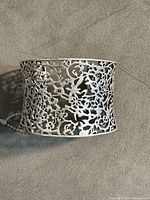Front view of wide floral openwork cuff bangle