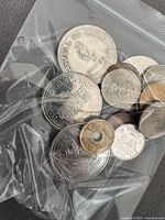 Bag showing variety of coins including Carnaval de Québec tokens, Canadian circulation coins and bimetallic $2 coin