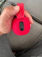 End view showing USB-C charging port and carry strap