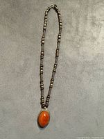 Full view of necklace showing bead pattern and pendant