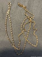 Full view of gold chain laid out showing link style