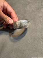 Full view of cuff showing floral engraving and cartouche