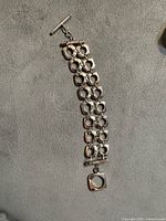 Full view of sterling silver bracelet with square links and toggle clasp