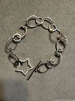 Full view of sterling silver link bracelet with star toggle