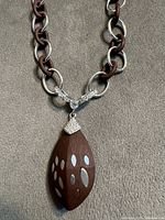 Front view showing alternating silver and wood links and pendant