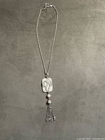 Full view of sterling silver necklace showing pendant and tassel