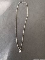 Full view of sterling silver necklace with square pendant