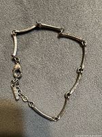 Full view of bracelet showing bar links and clasp
