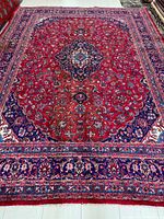 Full view of the rug showing field, borders, overall wear