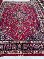 Full view of rug showing field, medallion and borders