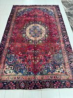 Full view of Persian Mashhad rug showing overall design and size