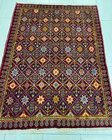 Full view of handmade Persian Tabriz rug showing overall design and borders