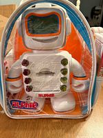 Front view of Alphie robot inside clear backpack packaging