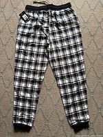 Full view of plaid lounge pants showing pattern, cuffs and waistband