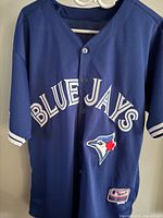 Front of blue Toronto Blue Jays jersey showing script and team logo