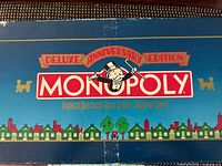 Box lid showing Monopoly Deluxe Anniversary Edition branding