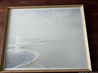 Full view of framed seascape photograph