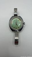 Front view of Timex Electric watch showing green dial and stretch bracelet