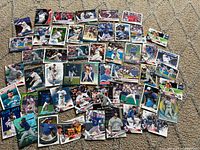 Wide view of entire assortment of Toronto Blue Jays cards spread on carpet