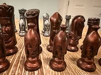 Front view of assorted copper and pewter ceramic chess pieces