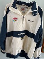 Front view showing logos, signature, quarter-zip design