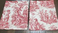 Two red toile valances laid flat showing full pattern