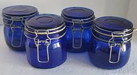 Front view of all four cobalt blue glass canisters