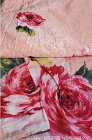 Folded sheet and pillowcases showing overall color and floral pattern